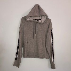 Bebe Sport grey hooded drawstring sweatshirt.